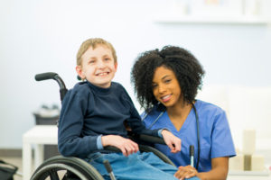 A child with special needs due to chromosome 8P inversion duplication syndrome with a doctor.