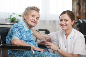 Senior woman with her caregiver at home
